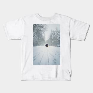 women walks the snowy street Kids T-Shirt